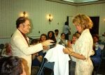 Dr. Fred presents Deanna Lund with a RoVaCon T-shirt in 1990
